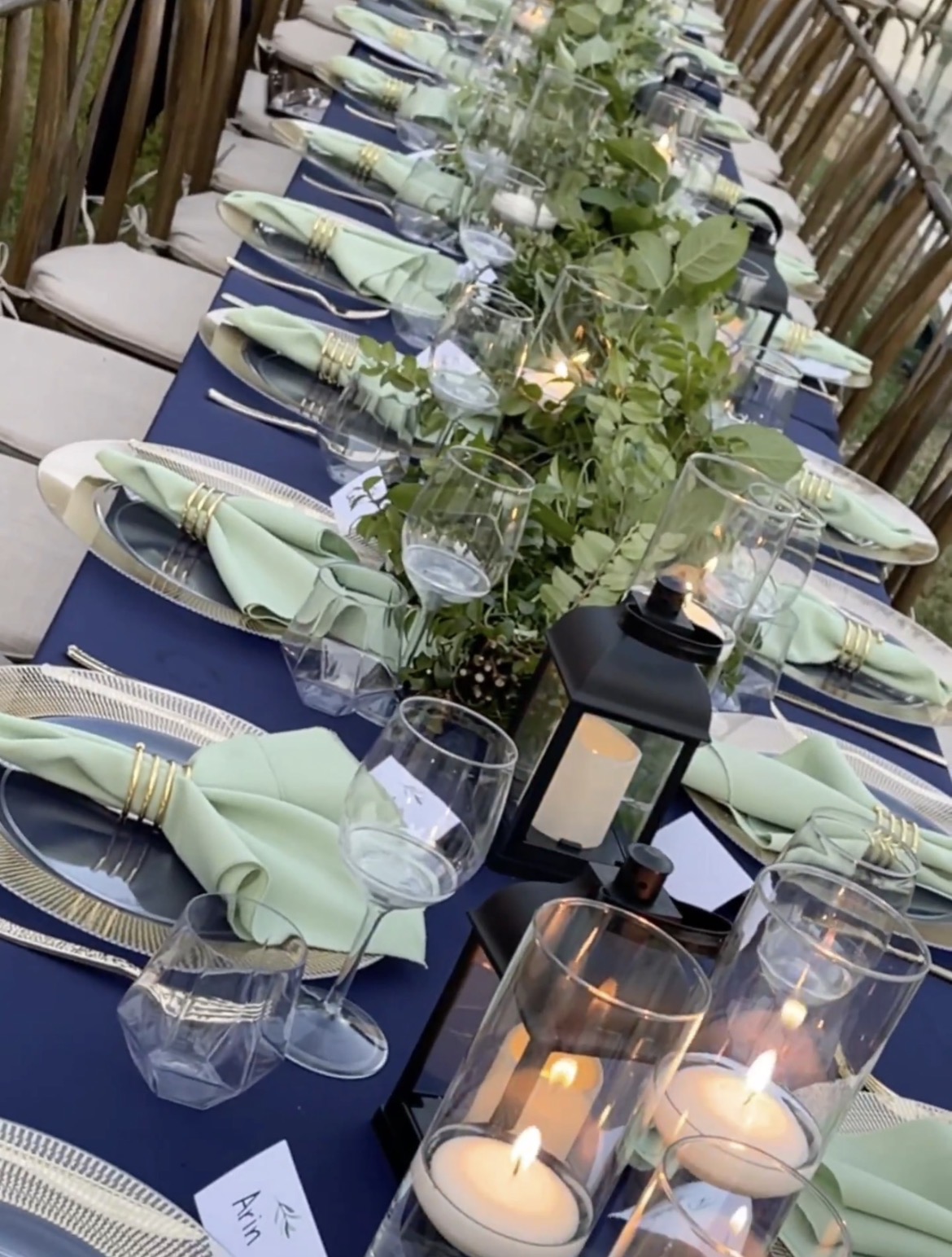 Long table with navy linens and fresh greenery