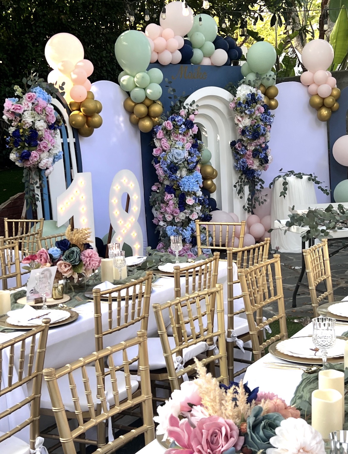 Pastel birthday setting with balloons and floral details