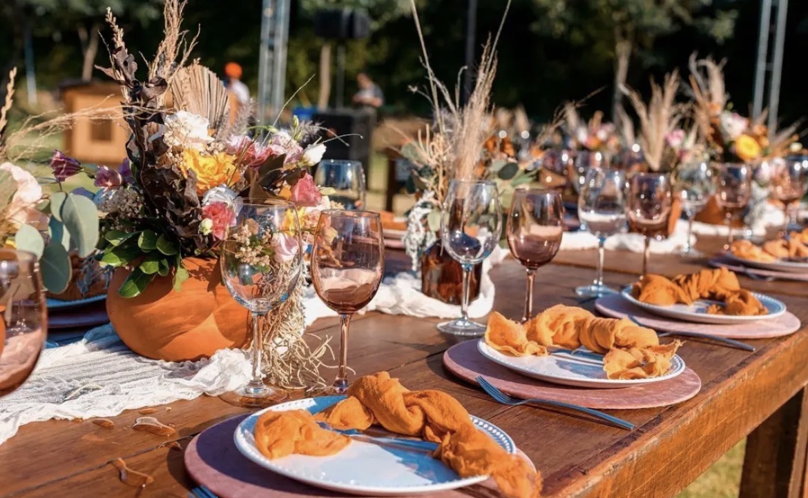 Autumn-inspired table with orange napkins and floral styling